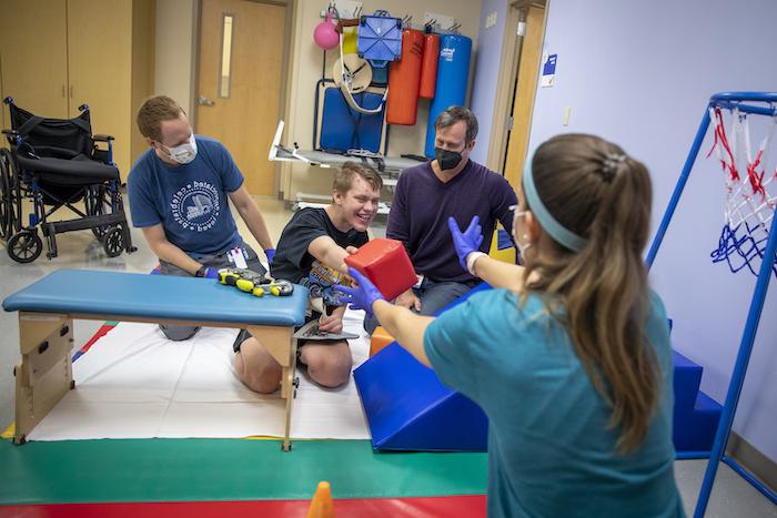 Patient Ethan working with the rehab team at Johns Hopkins All Children's Hospital