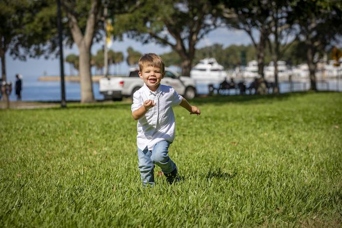 Patient Ethan running around outside in a park